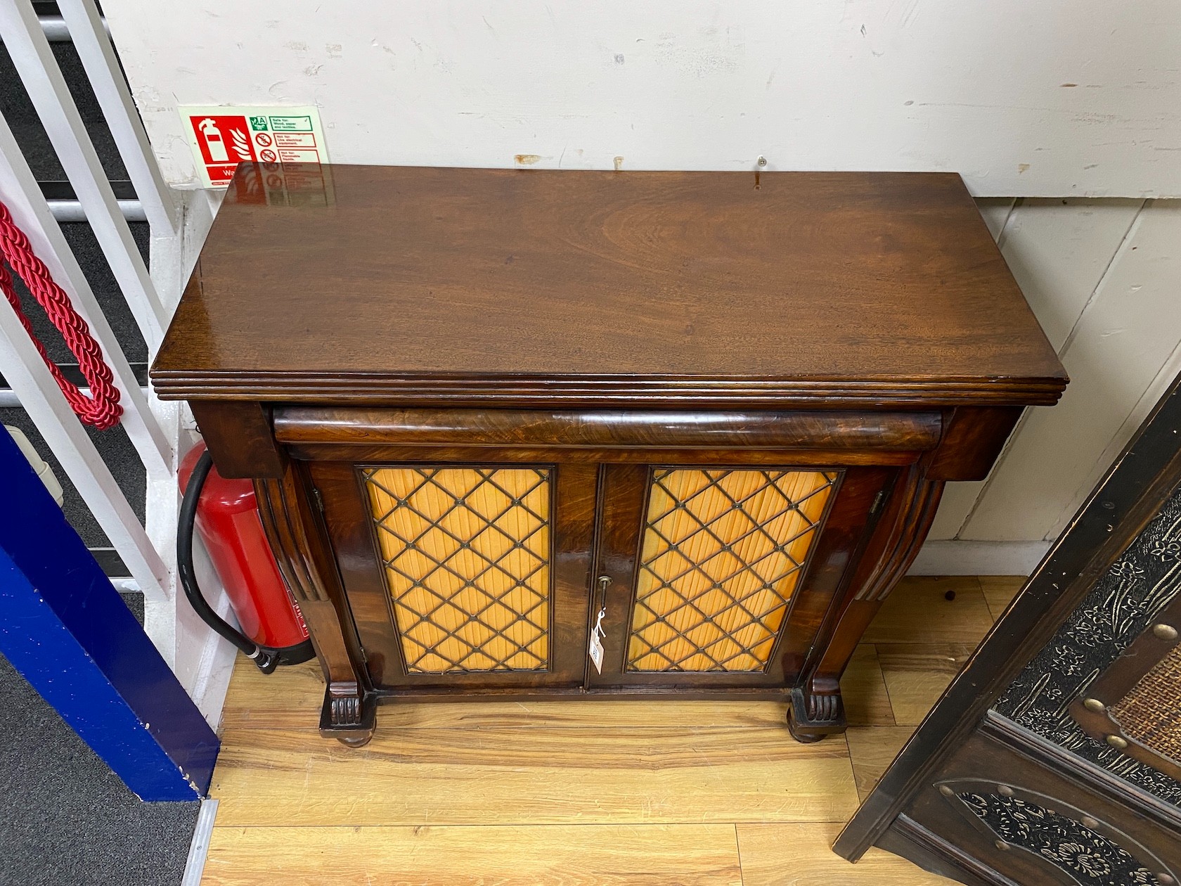 A William IV mahogany chiffonier, with pleated silk and brass grille doors, height 89cm, width 84cm, depth 35cm